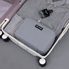 A gray portable waterproof travel toiletry bag is shown open inside a white suitcase with a striped lining and a small black 