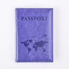 A purple leather passport holder with the word PASSPORT and a world map design.