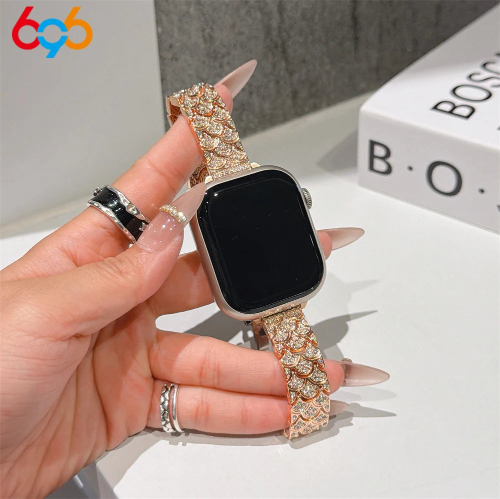 A hand is wearing a sparkling metal strap Apple Watch band with crystal fishscales on a black watch face.