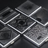 A collection of decorative metal cigarette storage boxes with intricate patterns and radiating designs.