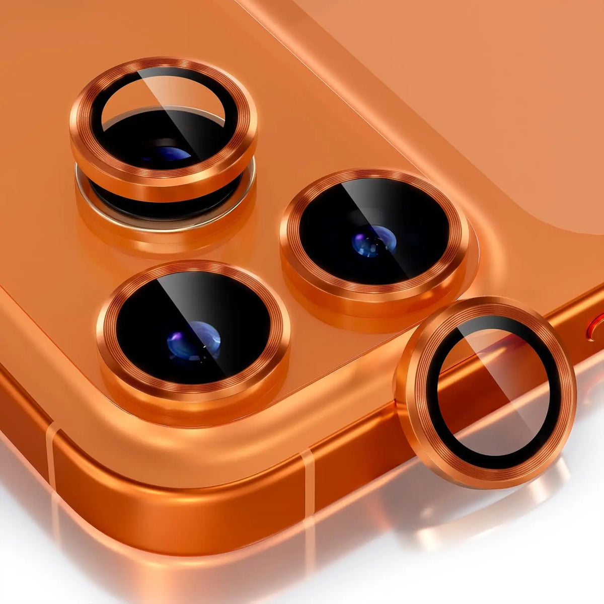 A close-up view of a glitter diamond camera lens protector with a metal frame resting on a smartphone.