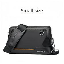 A small black leather crossbody bag with an adjustable strap shown in a flat lay view.