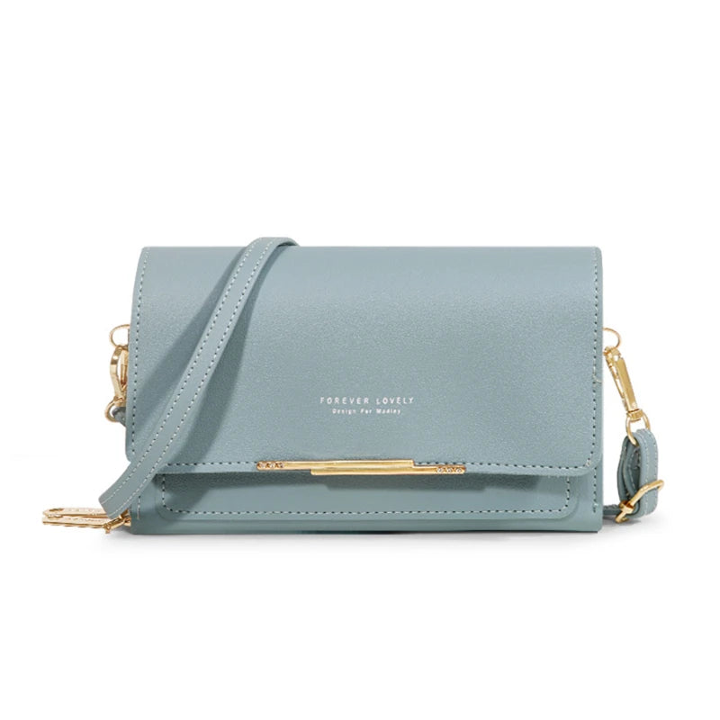 A light blue suede multi-card shoulder wallet with gold hardware and a matching strap.