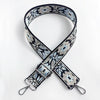 A black and white patterned jacquard strap for an adjustable crossbody bag.