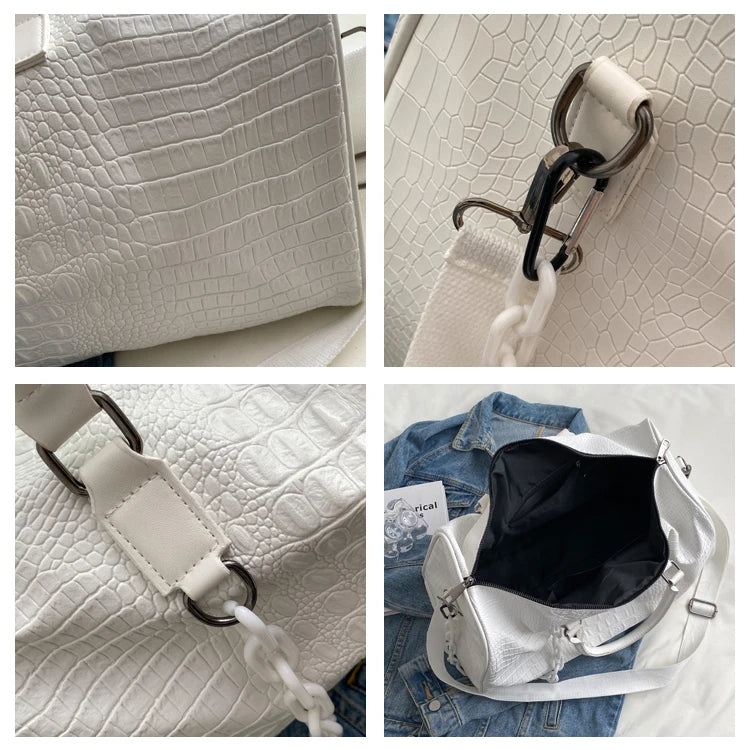 A white crocodile grain PU leather travel duffle bag with a black leather handle and white drawstring detail.
