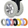 A set of silicone luggage wheels in various colors, including silver and multiple shades of blue, pink, black, yellow, purple
