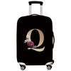 Black luggage with a gold letter Q design and silver handles