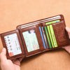 A brown leather wallet is shown open, displaying various cards and cash inside.