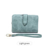 A light green women's multi-slot frosted card wallet with a leather strap.