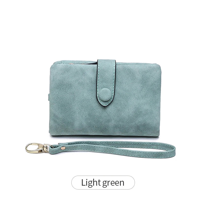 A light green women's multi-slot frosted card wallet with a leather strap.