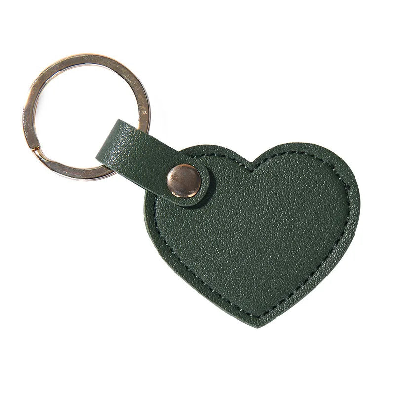 A dark olive green leather heart-shaped keychain with a metal ring and clasp.
