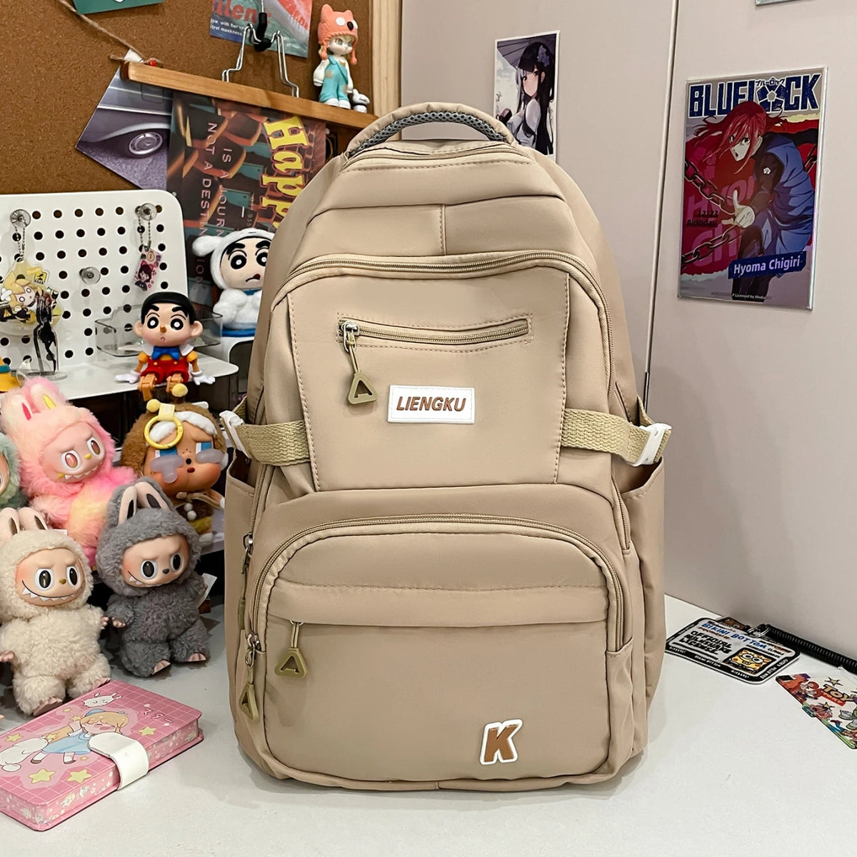 A beige lightweight nylon college backpack with multiple compartments and a strap visible.
