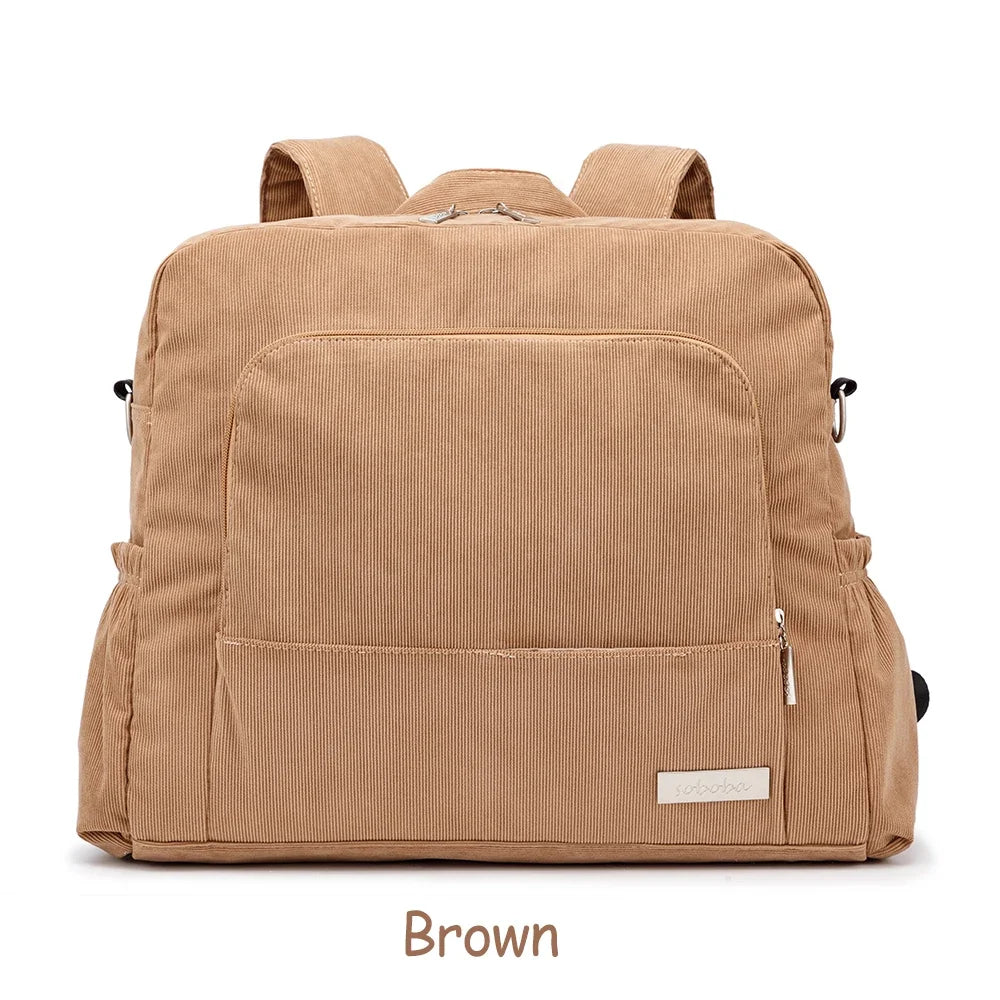 A brown soft corduroy diaper backpack for mothers shown from the back.