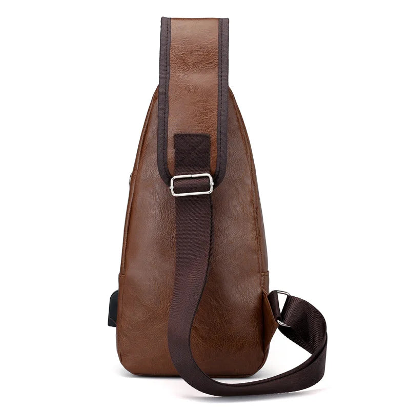 A brown leather men's chest bag with a strap and a rectangular metal plate detail.