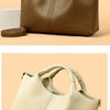 A brown luxury soft leather women's tote bag shown in a top-down view with a leather strap.