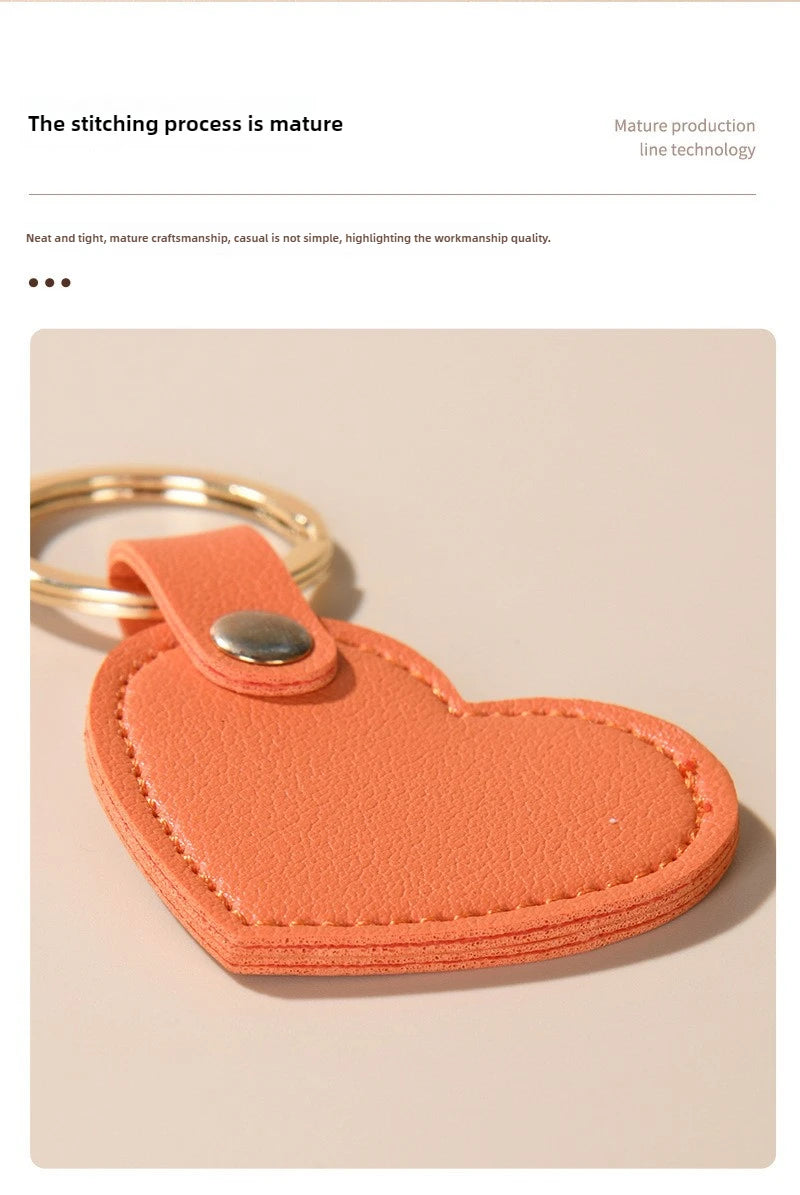 An orange leather heart-shaped keychain is shown against a light background.
