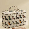 A quilted cosmetic travel bag featuring a repeating dachshund print, shown on a light surface.