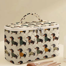 A quilted cosmetic travel bag featuring a repeating dachshund print, shown on a light surface.