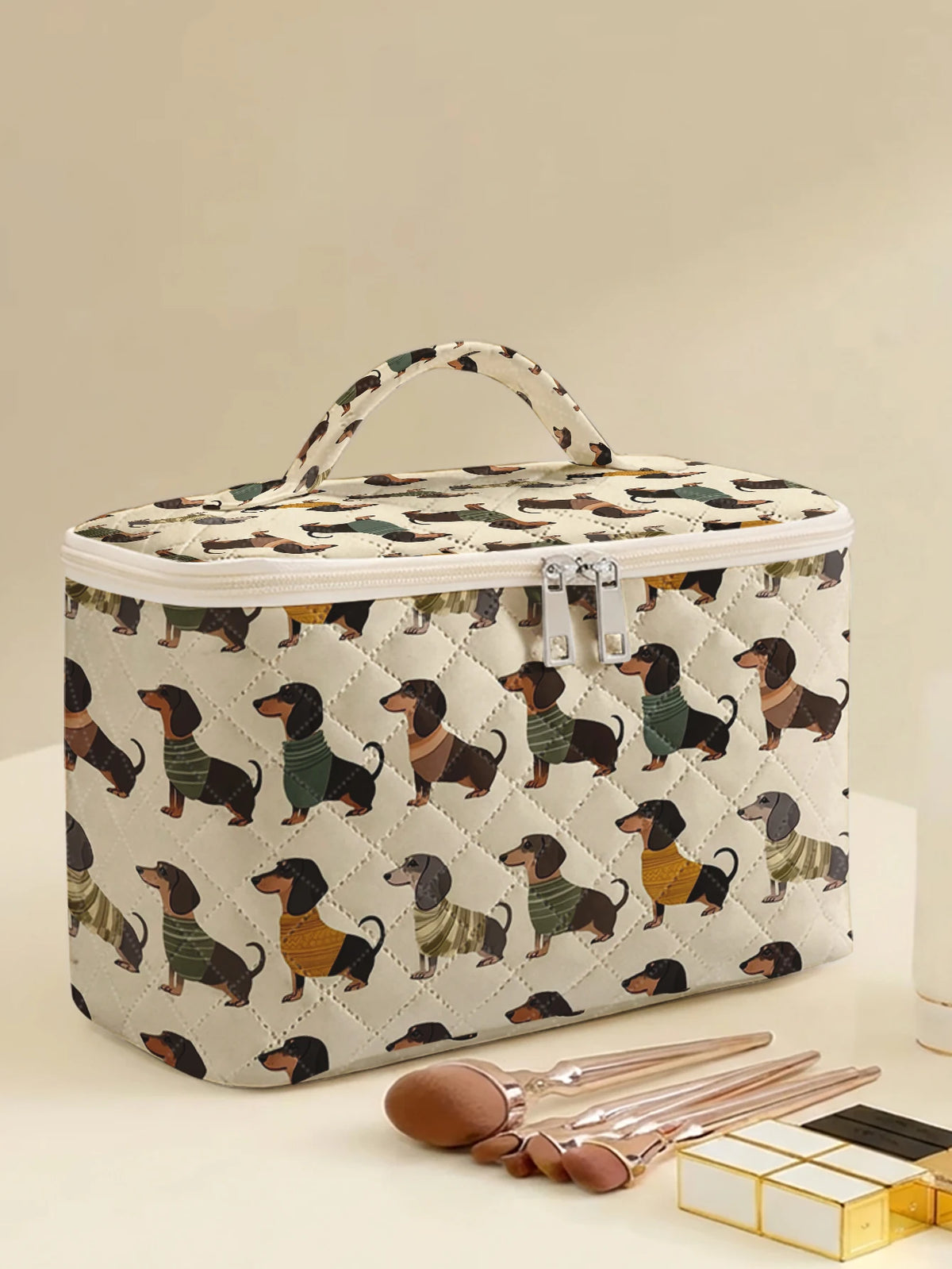 A quilted cosmetic travel bag featuring a repeating dachshund print, shown on a light surface.