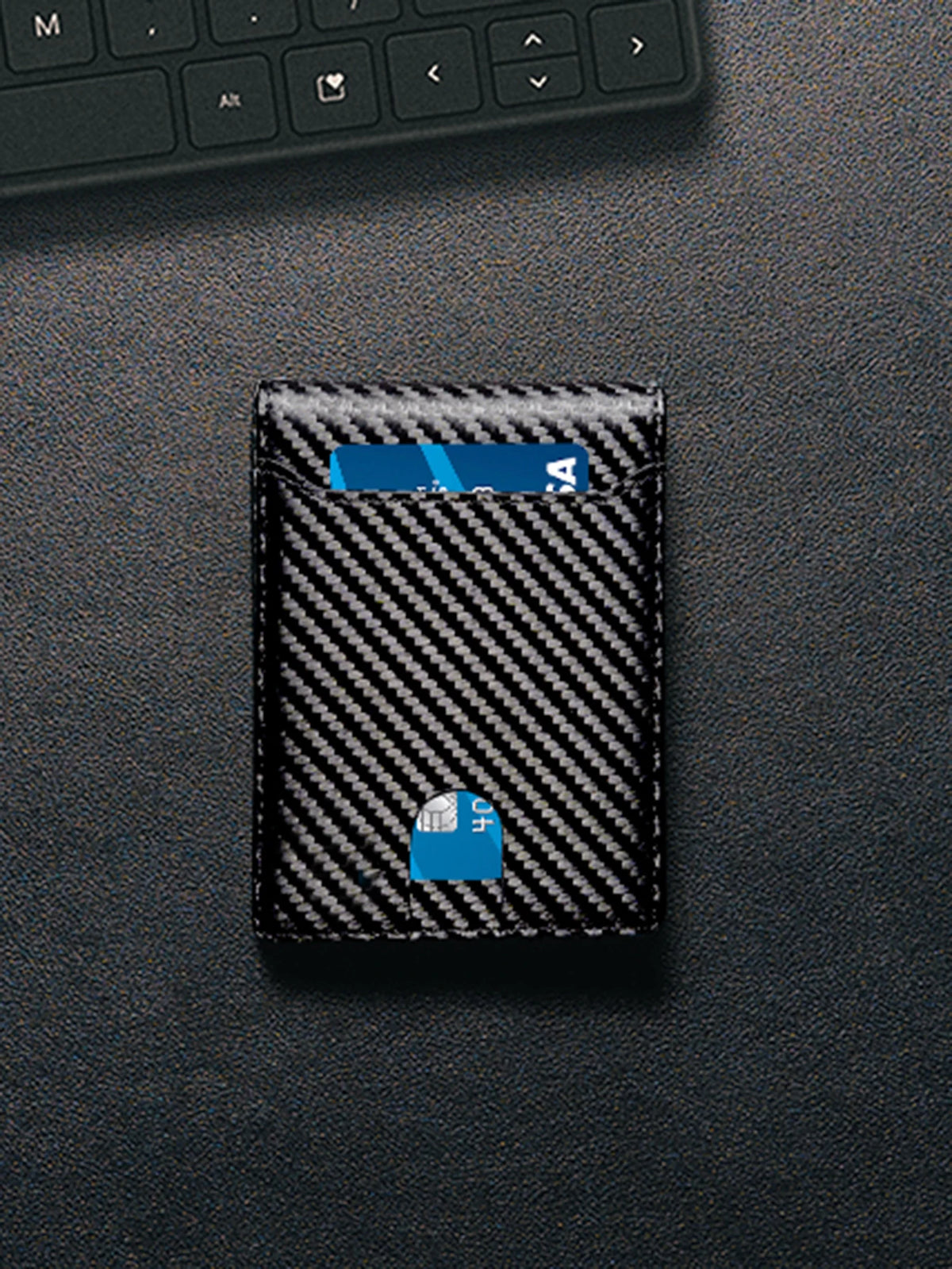 A black wallet with a carbon fiber texture and a blue RFID-blocking front pocket visible on a dark surface.