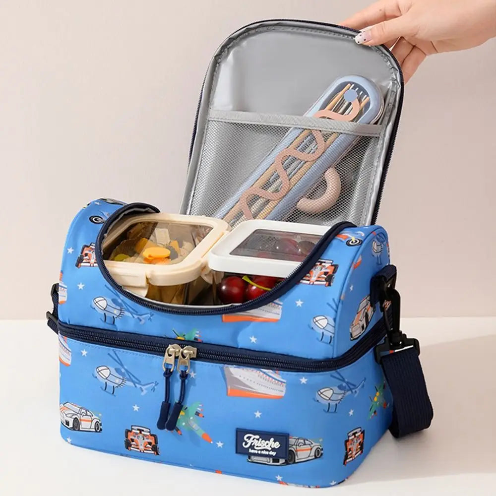 A blue insulated double-layer lunch bag with cartoon prints is shown open, displaying a stainless steel fork.