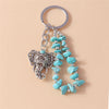 Silver keychain featuring an elephant pendant made of metal and turquoise beads