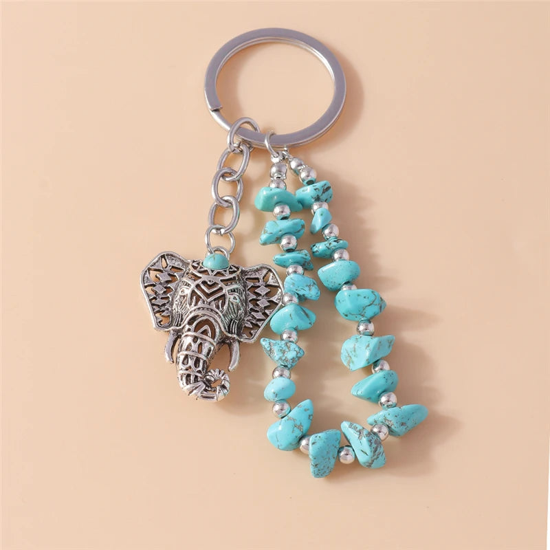 Silver keychain featuring an elephant pendant made of metal and turquoise beads