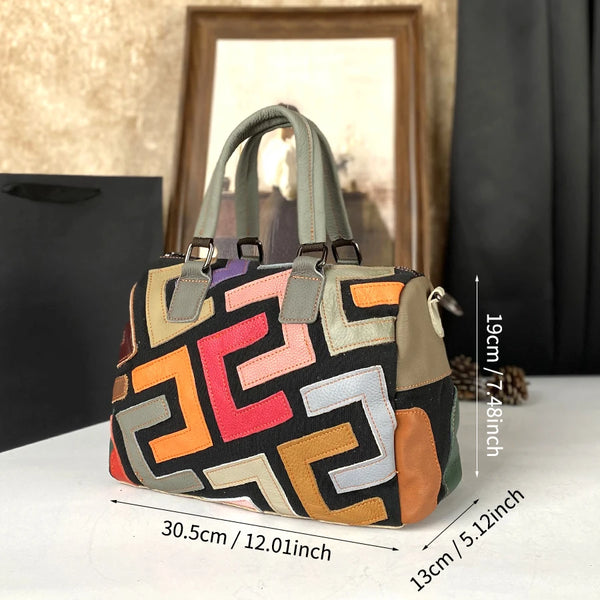A geometric patterned genuine leather crossbody bag in earthy tones resting on a white surface.