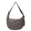 A gray canvas crossbody bag with adjustable straps and a drawstring closure.