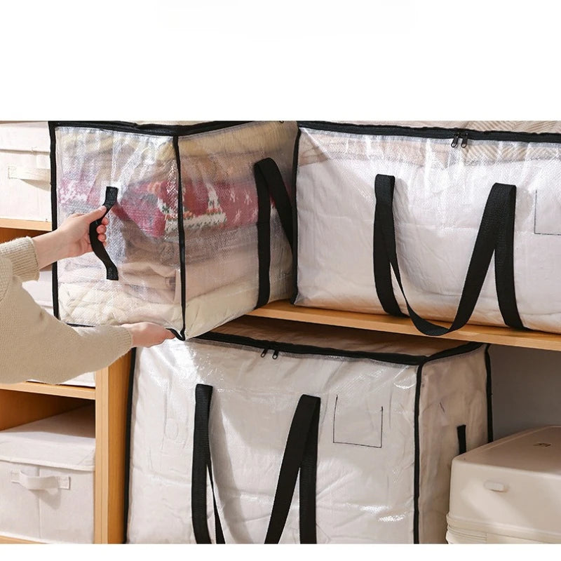 A hand is opening a large transparent woven storage bag with black straps on a wooden shelf.