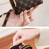 A close-up of a black leather card bag with gold hardware and a repeating pattern, shown being held by a hand.