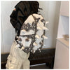 A black and white hedgehog shaped PU backpack worn by a person.