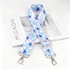 Light blue and pink geometric pattern nylon strap with a silver metal buckle
