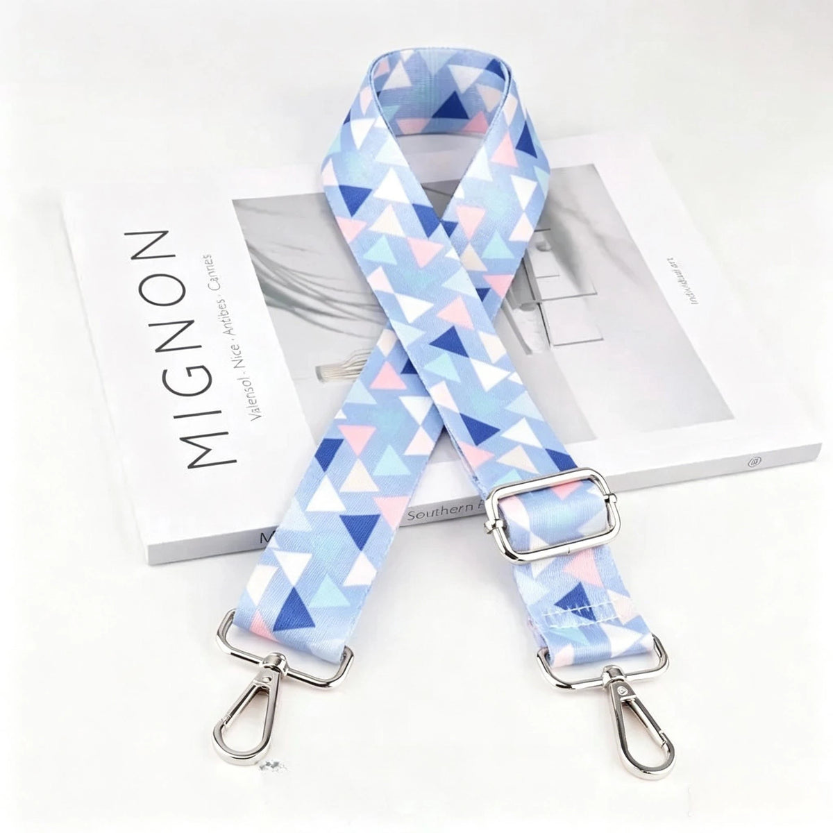 Light blue and pink geometric pattern nylon strap with a silver metal buckle