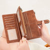 A brown leather trifold clutch wallet is shown being opened and closed, displaying various card slots.
