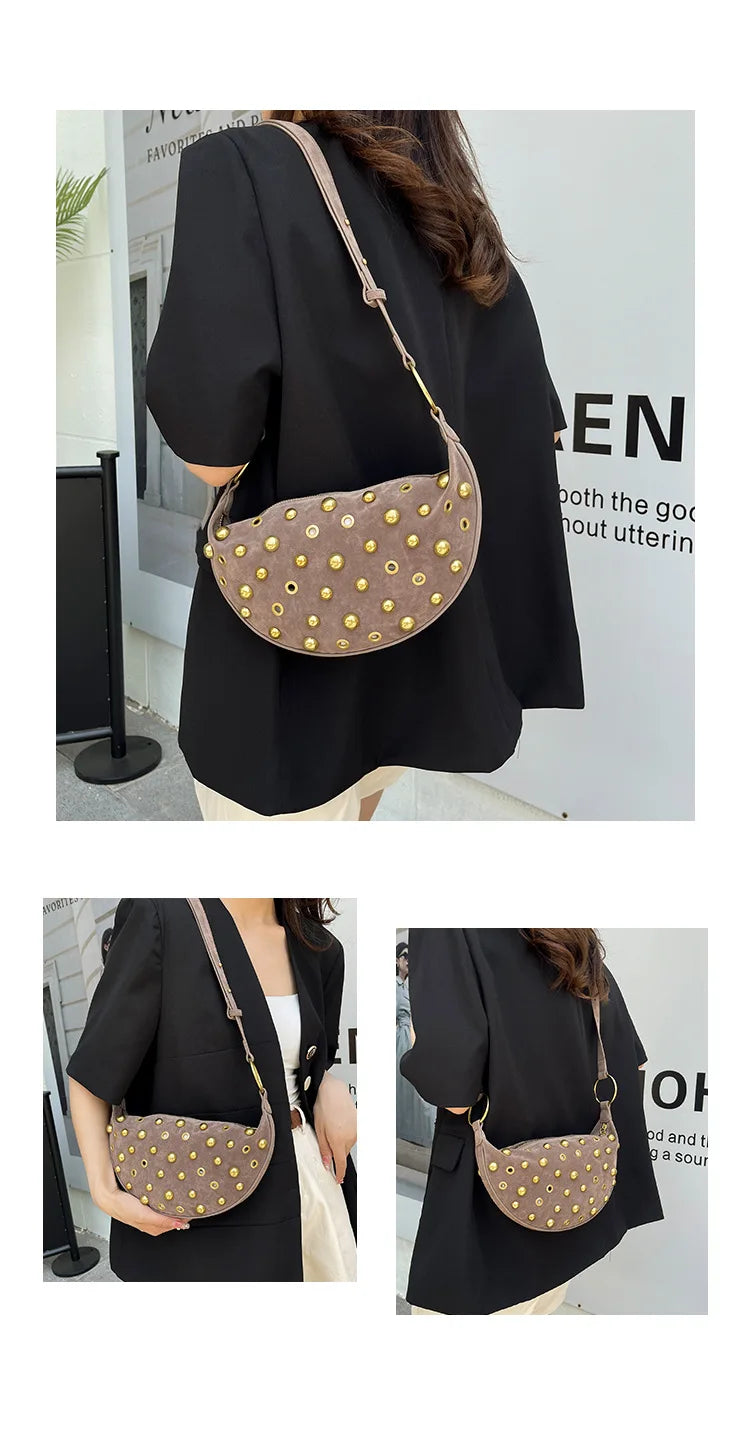 A dark brown faux suede hobo crossbody bag with gold rivet accents worn by a woman.