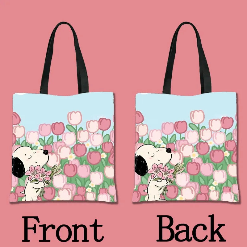 A pair of light blue tote bags featuring a pattern of pink and green tulips with cartoon dogs.