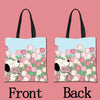 A pair of light blue tote bags featuring a pattern of pink and green tulips with cartoon dogs.