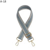 A gray woven adjustable crossbody strap with gold-toned hardware.