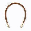 A brown leather strap with a textured finish and metal buckles, used as a replacement bag handle.