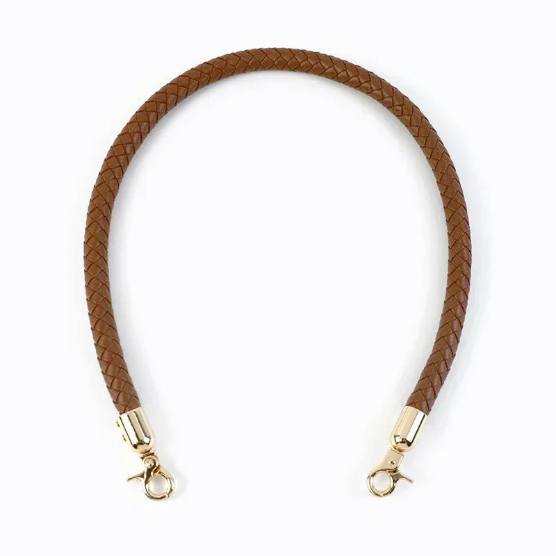 A brown leather strap with a textured finish and metal buckles, used as a replacement bag handle.