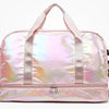 A pink iridescent nylon travel bag with light pink straps and a silver zipper.