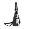 A black and white cow print PU leather tote bag with long handles.