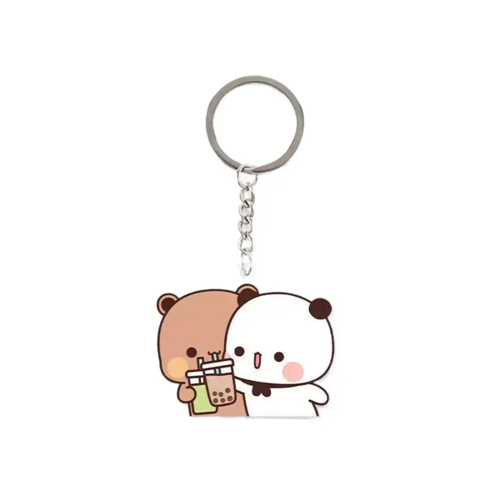 A cute cartoon keychain charm featuring two pandas, one brown and one white, attached to a silver ring.