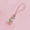 A pink strawberry resin charm keychain with a pink cord and silver clasp