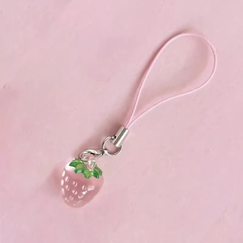 A pink strawberry resin charm keychain with a pink cord and silver clasp