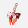 Pink and brown patterned adjustable bag strap with a gold-tone clasp.