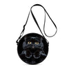 A black cartoon cat round crossbody bag with a thin black strap.