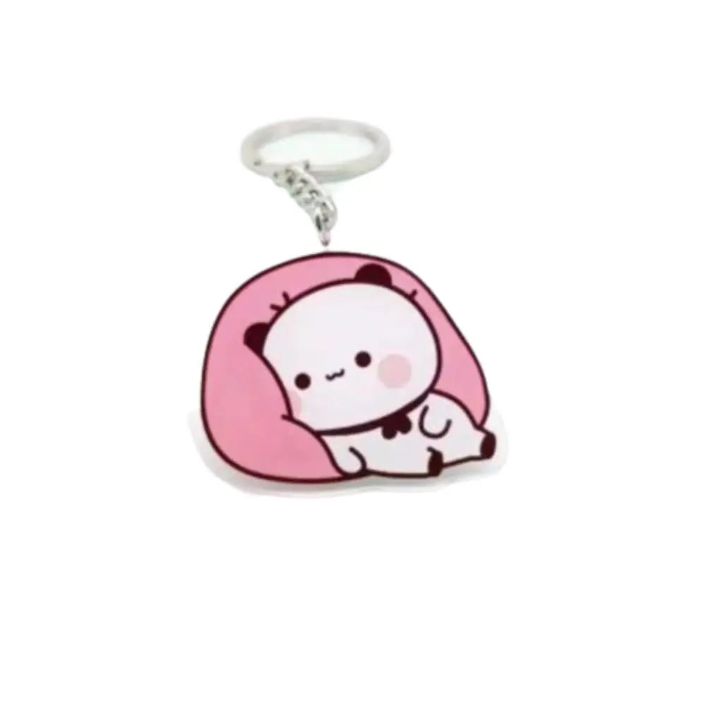 A pink and white cartoon bear charm keychain made of resin