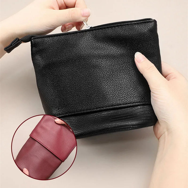 A black stretchable PU leather makeup brush storage case being held by a hand, showing the texture and closure.